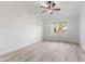 Bright bedroom with large window, ceiling fan, and light wood flooring at 8383 W Utopia N Rd, Peoria, AZ 85382