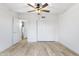 Spacious bedroom with light wood floors and mirrored closet doors at 8383 W Utopia N Rd, Peoria, AZ 85382