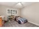 Well-lit bedroom with a twin bed and plenty of bookshelves at 8435 E Catalina Dr, Scottsdale, AZ 85251