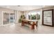 Bright dining room with wooden table, bench, and sliding glass doors at 8435 E Catalina Dr, Scottsdale, AZ 85251