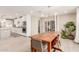 Dining area with wooden table and view into updated kitchen at 8435 E Catalina Dr, Scottsdale, AZ 85251