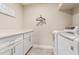 Laundry room with white cabinets, washer, and dryer at 8435 E Catalina Dr, Scottsdale, AZ 85251