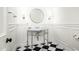 Elegant powder room with marble sink, black and white checkered floor at 8601 N 64Th Pl, Paradise Valley, AZ 85253