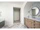 Elegant bathroom with marble vanity, large mirror, and decorative tile at 8601 N 64Th Pl, Paradise Valley, AZ 85253