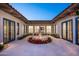 Tranquil courtyard featuring a central fountain and red flowers at 8601 N 64Th Pl, Paradise Valley, AZ 85253