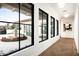 Bright hallway with herringbone floors and views to a courtyard at 8601 N 64Th Pl, Paradise Valley, AZ 85253