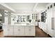 Modern kitchen featuring double islands, white cabinetry, and marble countertops at 8601 N 64Th Pl, Paradise Valley, AZ 85253