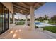 Covered patio with outdoor lighting overlooking the pool at 8601 N 64Th Pl, Paradise Valley, AZ 85253