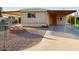 Mobile home exterior with carport and gravel driveway at 8627 E Dulciana Ave # 43, Mesa, AZ 85208