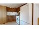 Small kitchen with wood cabinets and a white refrigerator at 8627 E Dulciana Ave # 43, Mesa, AZ 85208