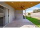 Covered patio with ceiling fan, access to backyard, and concrete flooring at 8828 E Des Moines St, Mesa, AZ 85207