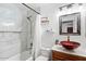 Bathroom with tub, shower, red glass sink, and granite vanity at 8828 E Des Moines St, Mesa, AZ 85207