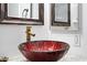 Bathroom detail featuring a red glass vessel sink and gold faucet at 8828 E Des Moines St, Mesa, AZ 85207