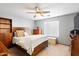 Spacious bedroom with wooden furniture and ceiling fan at 8828 E Des Moines St, Mesa, AZ 85207