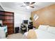 Bedroom with a queen bed, desk, bookshelf, and ceiling fan at 8828 E Des Moines St, Mesa, AZ 85207