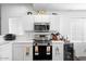 Stainless steel appliances and white cabinetry in this kitchen at 8828 E Des Moines St, Mesa, AZ 85207