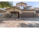 Two-story house with a brown garage door and landscaping at 9420 S 35Th Gln, Laveen, AZ 85339