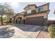 Two-story house with a brown garage door and gravel driveway at 9420 S 35Th Gln, Laveen, AZ 85339