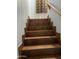 Indoor staircase with brown tile and wooden handrail at 9420 S 35Th Gln, Laveen, AZ 85339