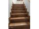 Indoor staircase with brown tile and wooden handrail at 9420 S 35Th Gln, Laveen, AZ 85339