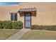 Front entry of tan stucco house with tiled awning and black metal door at 948 S Alma School Rd Rd # 89, Mesa, AZ 85210