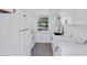 Modern white kitchen with quartz countertops and black sink at 948 S Alma School Rd Rd # 89, Mesa, AZ 85210