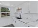 Modern white kitchen with a black faucet and quartz countertops at 948 S Alma School Rd Rd # 89, Mesa, AZ 85210