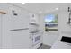 Modern white kitchen with black appliances and quartz countertops at 948 S Alma School Rd Rd # 89, Mesa, AZ 85210