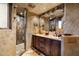 Spa-like bathroom with double vanity, stone shower, and large mirror at 9839 E Madera E Dr, Scottsdale, AZ 85262