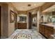 Double vanity bathroom with stone flooring and wooden cabinets at 9839 E Madera E Dr, Scottsdale, AZ 85262