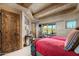 Bedroom with two twin beds, wooden accents, and a view of the desert landscape at 9839 E Madera E Dr, Scottsdale, AZ 85262