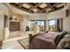 Large bedroom with wooden bed, fireplace, and stunning mountain views at 9839 E Madera E Dr, Scottsdale, AZ 85262