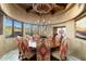 Circular dining room with large windows and unique chandelier at 9839 E Madera E Dr, Scottsdale, AZ 85262