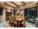 Rustic southwestern dining room with wood table and chairs, and access to a patio at 9839 E Madera E Dr, Scottsdale, AZ 85262