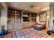 Rustic library with built-in wooden shelving and comfortable seating at 9839 E Madera E Dr, Scottsdale, AZ 85262