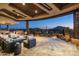 Large stone patio with seating area and mountain views at 9839 E Madera E Dr, Scottsdale, AZ 85262