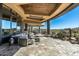 Relaxing patio features a stone floor, comfortable seating, and large windows at 9839 E Madera E Dr, Scottsdale, AZ 85262