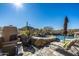 Resort-style pool and spa with a fireplace, lounge chairs and mountain views at 9839 E Madera E Dr, Scottsdale, AZ 85262