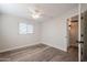 Spacious bedroom featuring wood-look floors and ceiling fan at 11380 N 113Th Dr, Youngtown, AZ 85363