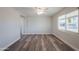 Bright living room has wood-look floors, a ceiling fan, and white brick walls at 11380 N 113Th Dr, Youngtown, AZ 85363