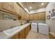 Laundry room with ample cabinetry and a utility sink at 12424 E Poinsettia Dr, Scottsdale, AZ 85259