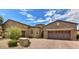 Stunning two-story home with stone exterior and a three-car garage at 12617 W Mine Trl, Peoria, AZ 85383