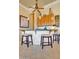 A well-equipped kitchen with a bar area featuring granite countertops, seating, and decorative lighting fixtures at 12617 W Mine Trl, Peoria, AZ 85383