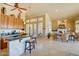 Open kitchen view with breakfast bar leading to the living area in an airy and inviting home design at 12617 W Mine Trl, Peoria, AZ 85383