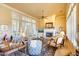Inviting living area featuring a fireplace, window shutters, and comfortable furnishings in an open layout at 12617 W Mine Trl, Peoria, AZ 85383