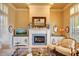 Cozy living room features a fireplace, stylish decor, and comfortable seating in a well-lit space at 12617 W Mine Trl, Peoria, AZ 85383
