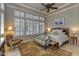 Bright and airy main bedroom featuring a king-size bed and a sitting area at 12617 W Mine Trl, Peoria, AZ 85383
