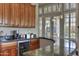 Curved wet bar with granite countertop and beverage fridge at 12617 W Mine Trl, Peoria, AZ 85383
