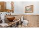 Elegant bathroom with mosaic sink, ornate mirror, and neutral tile at 14216 E Desert Cove Ave, Scottsdale, AZ 85259