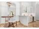 Stylish wet bar with a curved design, wine cooler, and glass-front cabinetry at 14216 E Desert Cove Ave, Scottsdale, AZ 85259